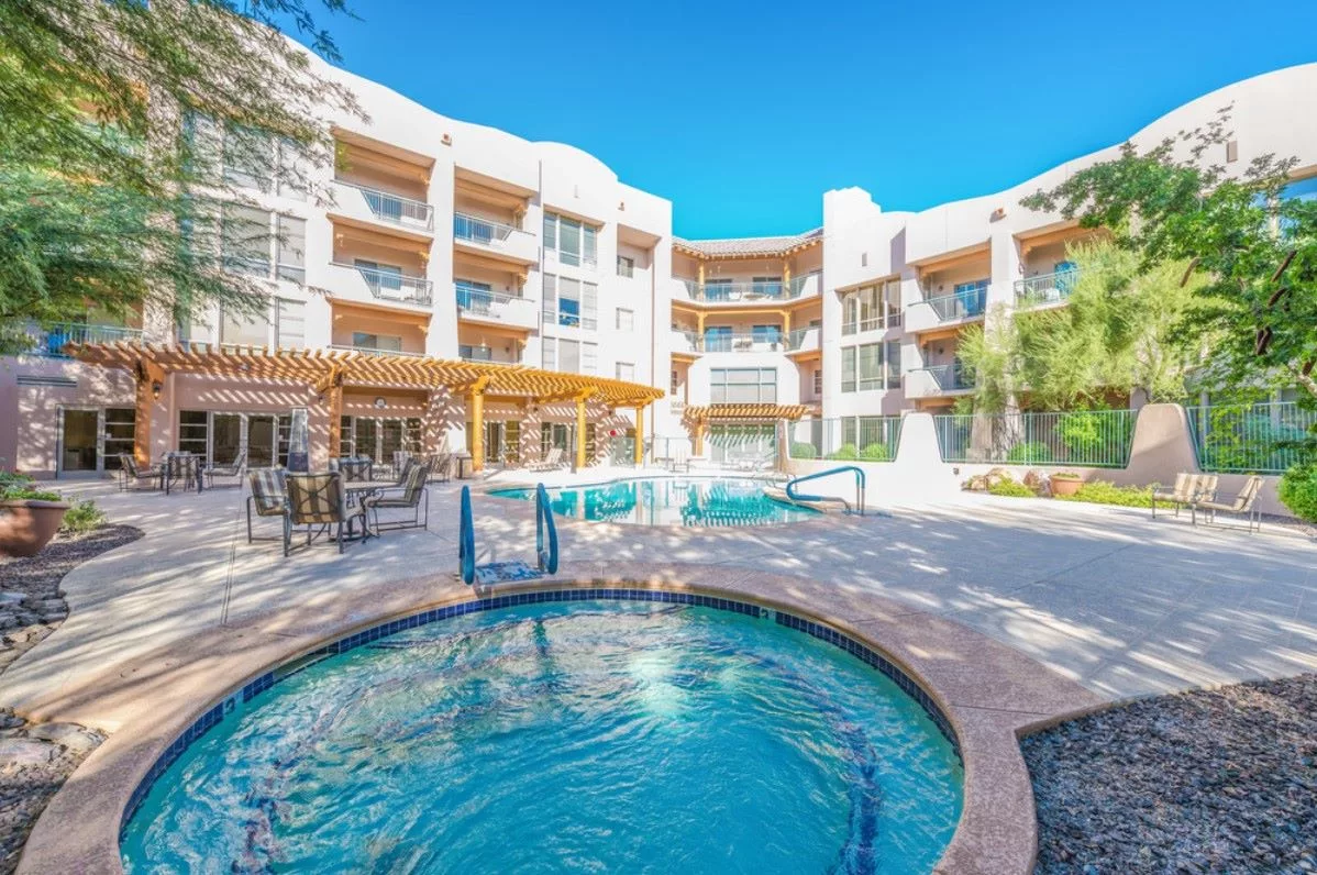 A luxurious resort with an outdoor pool area surrounded by modern architecture.