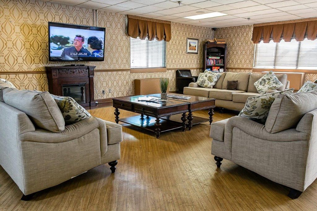 A cozy living room with comfortable sofas and a television.