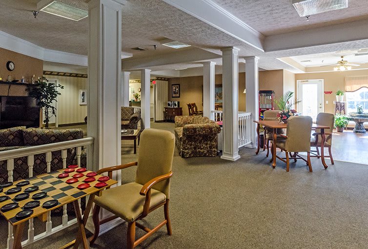 A cozy indoor seating area with a game table set up for checkers.