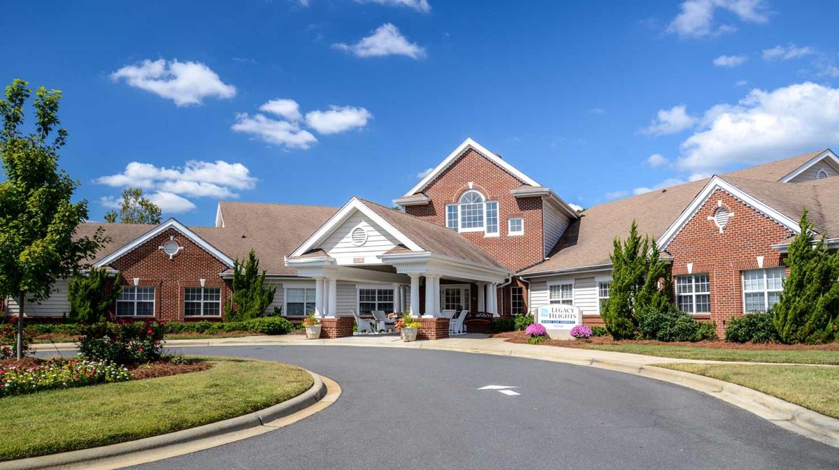A well-maintained senior living facility with a welcoming entrance and landscaped surroundings.