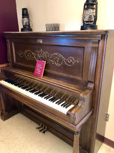 A beautifully crafted vintage piano with intricate detailing and a rich wood finish.