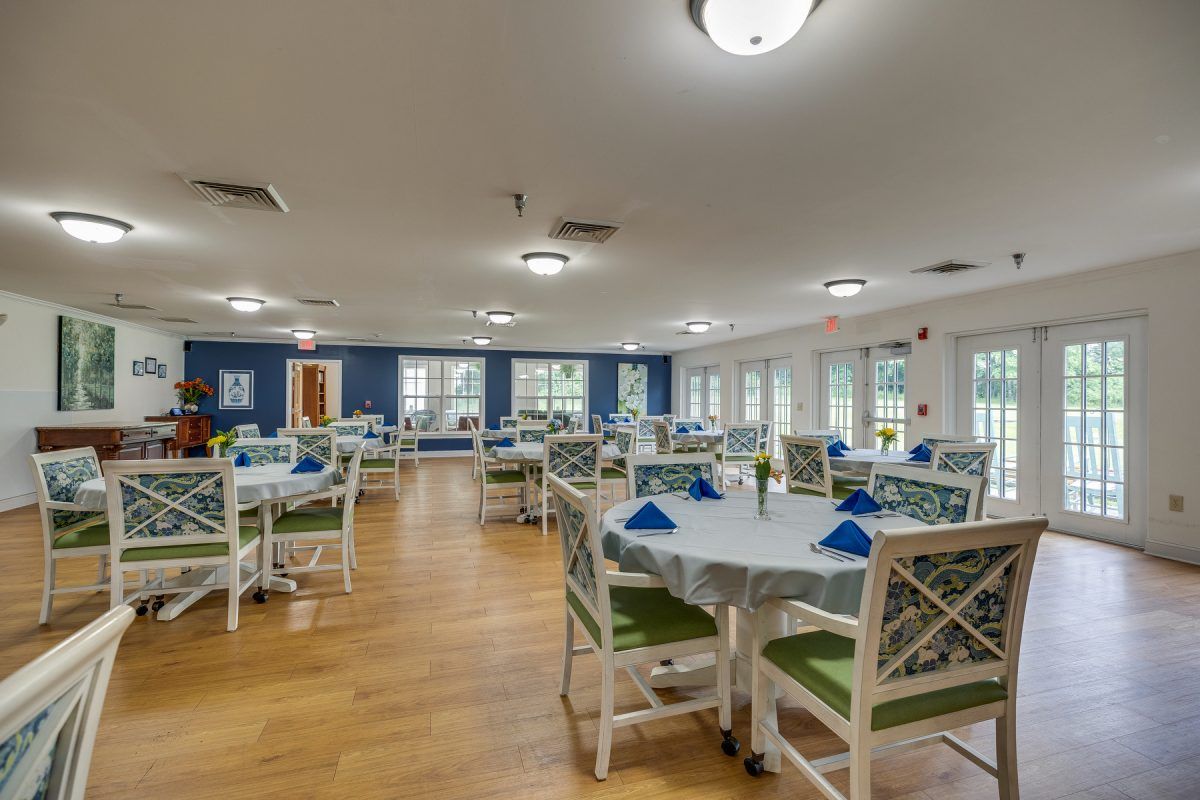 A well-lit dining area with multiple tables and chairs, featuring a cozy and inviting atmosphere.