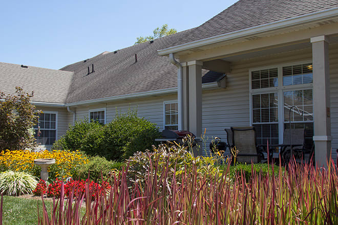 A cozy home with a well-maintained garden and a covered porch.
