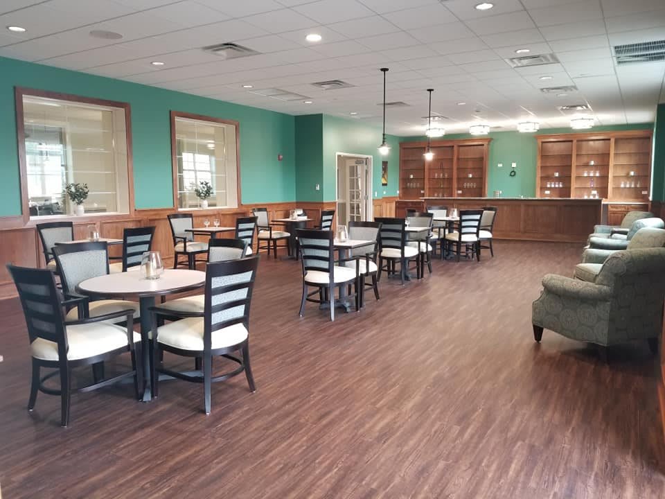 Spacious dining area with neatly arranged tables and chairs, featuring a stylish interior design.