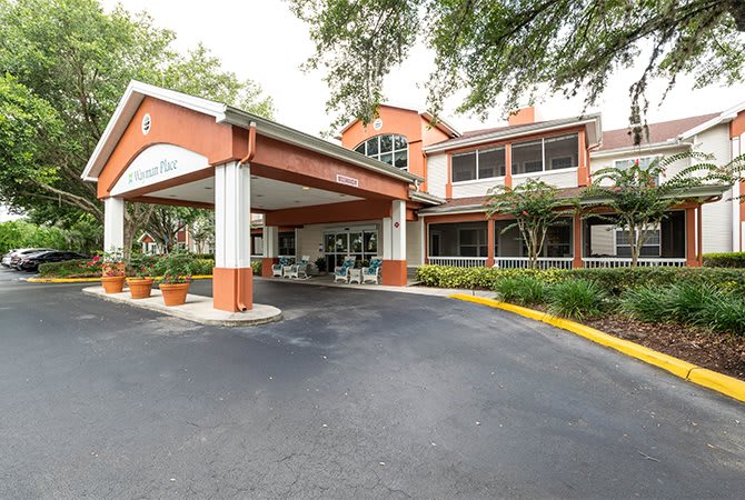 Entrance to a building with surrounding trees and landscaping.