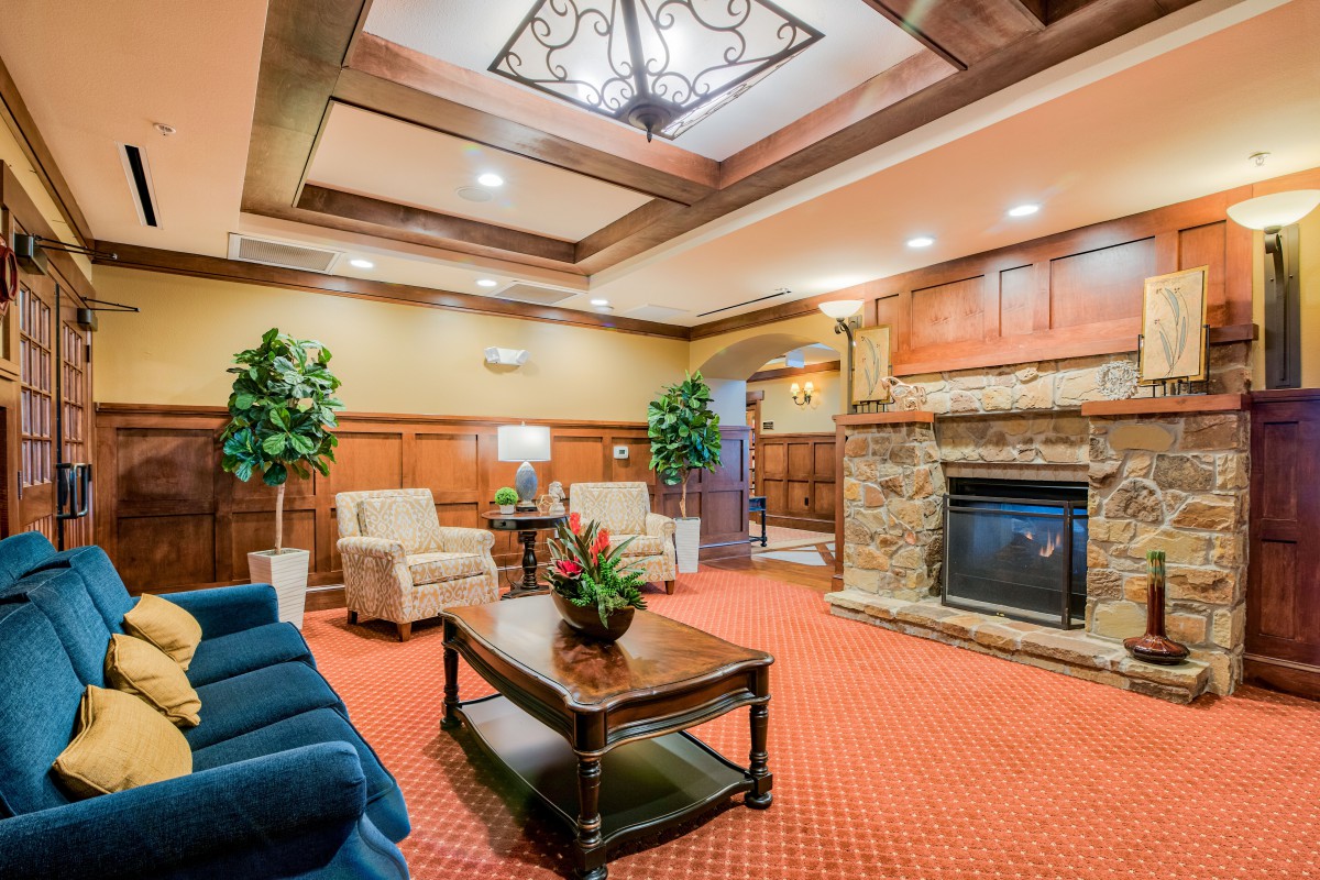 A cozy hotel lobby with comfortable seating and a fireplace.