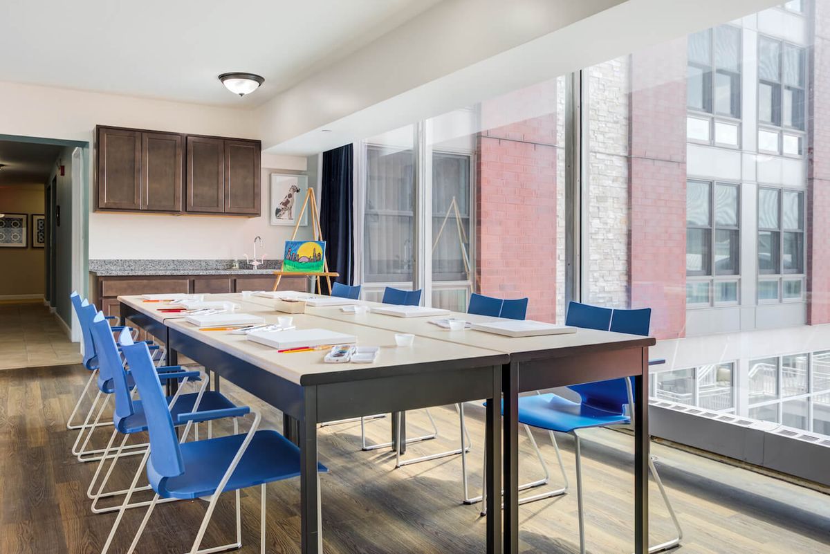 A modern meeting room with a large conference table and bright natural lighting.