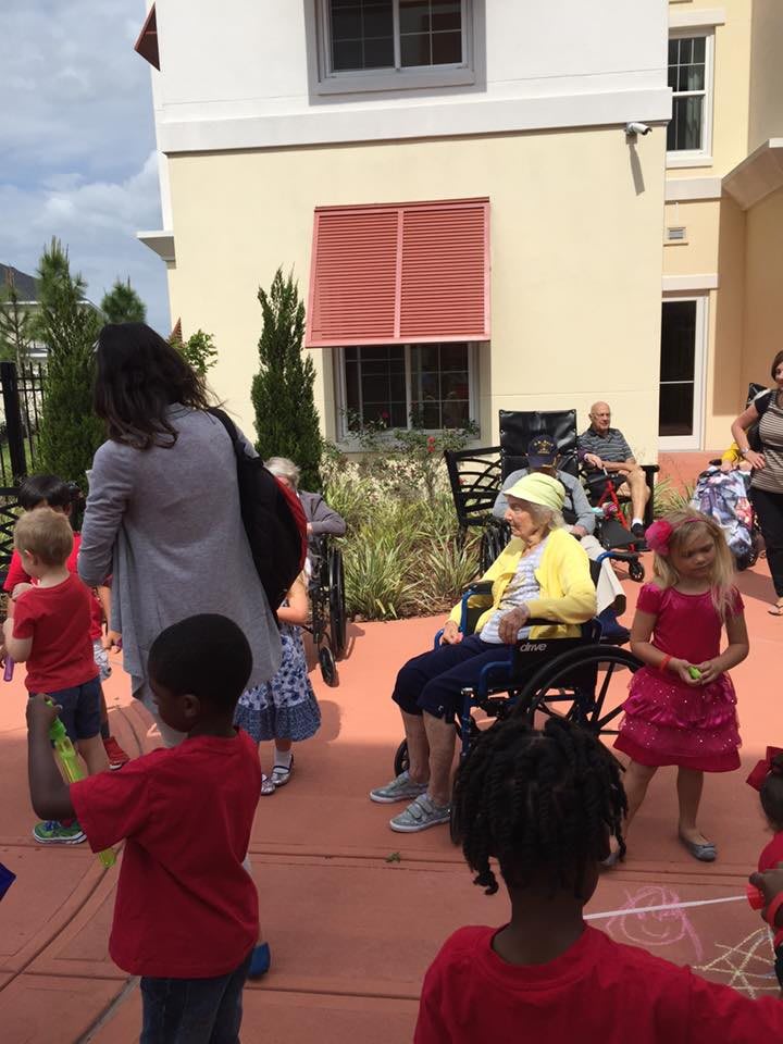 A group of children and seniors enjoying an outdoor event together.