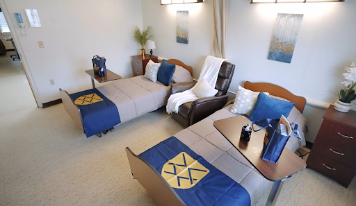A cozy and well-furnished bedroom featuring two beds, comfortable seating, and tasteful decor.
