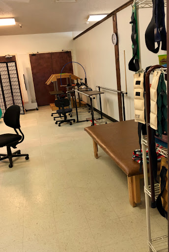 A view of a treatment room equipped for physical therapy and rehabilitation.