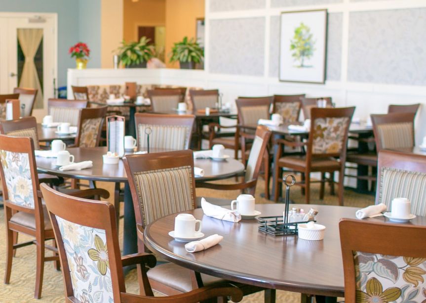An empty restaurant dining area set up with tables and chairs.