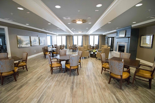 A spacious and modern dining room featuring ample seating, large windows for natural light, and elegant decor.