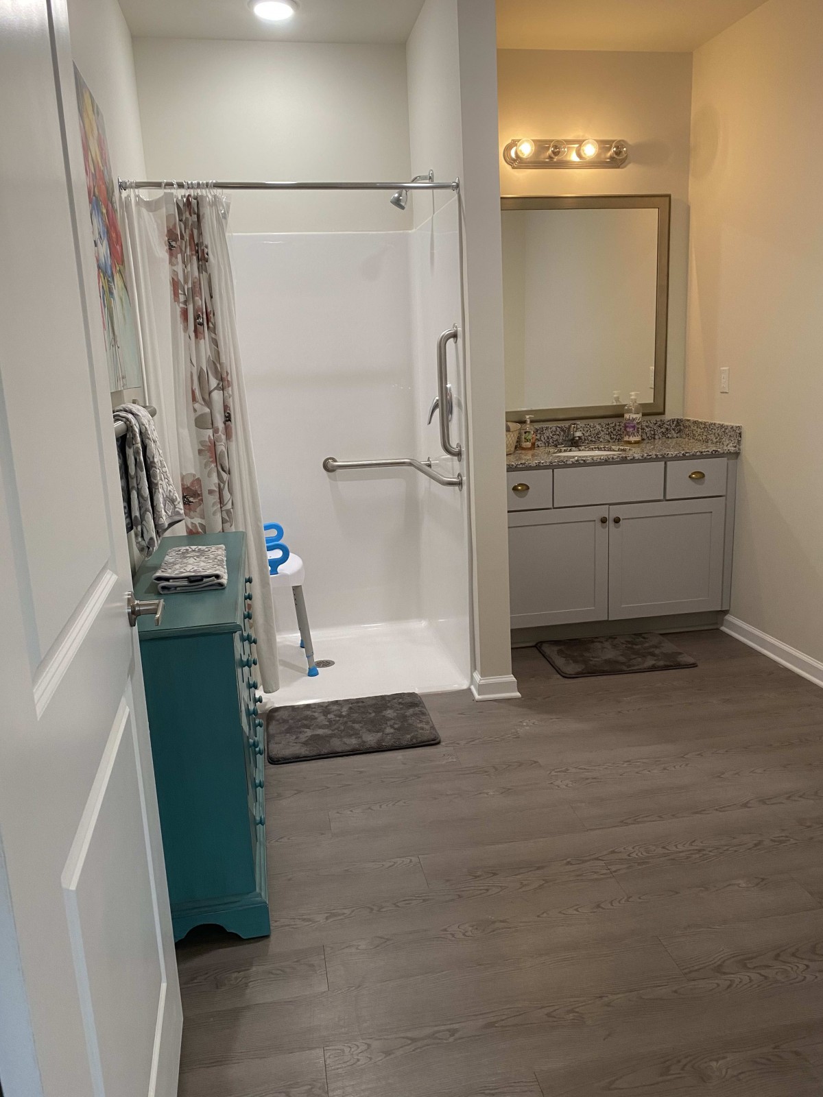 A modern bathroom with a walk-in shower and vanity sink.