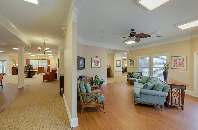 A cozy living room with comfortable seating and a view of the hallway.