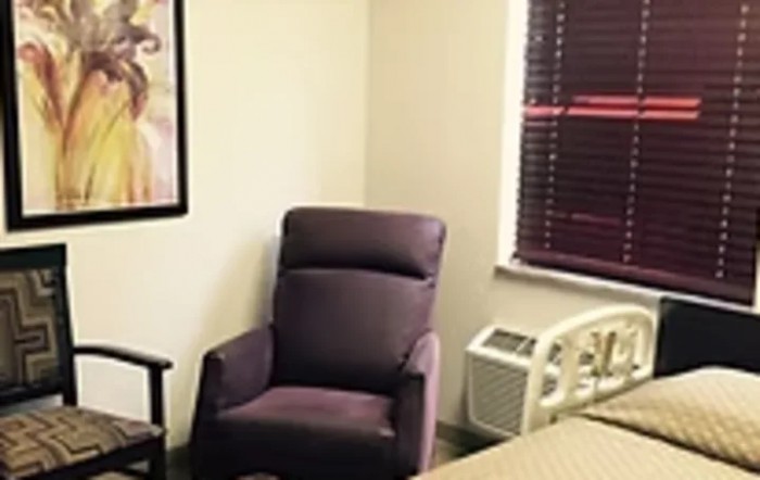 A cozy room featuring a comfortable armchair beside a window.