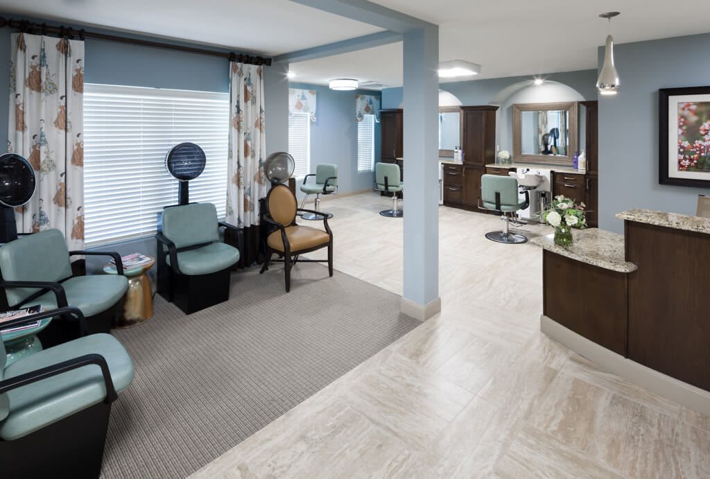 A modern and clean beauty salon interior with stylish chairs and mirrors.