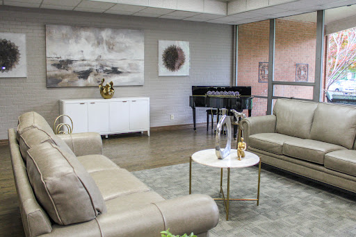 A stylish modern living room featuring comfortable seating, elegant decor, and a piano.