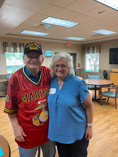 A joyful moment shared between two friends at a community event.