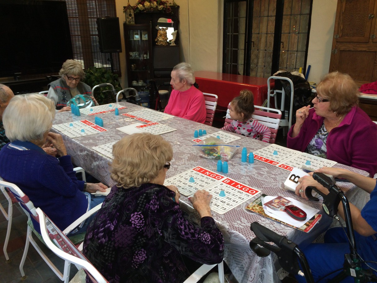 A group of elderly individuals enjoying a lively game of bingo together.