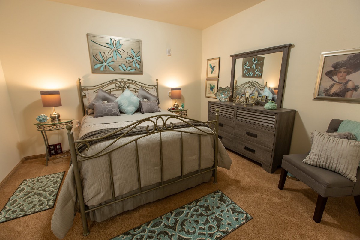 A cozy bedroom with elegant furnishings and soft lighting.
