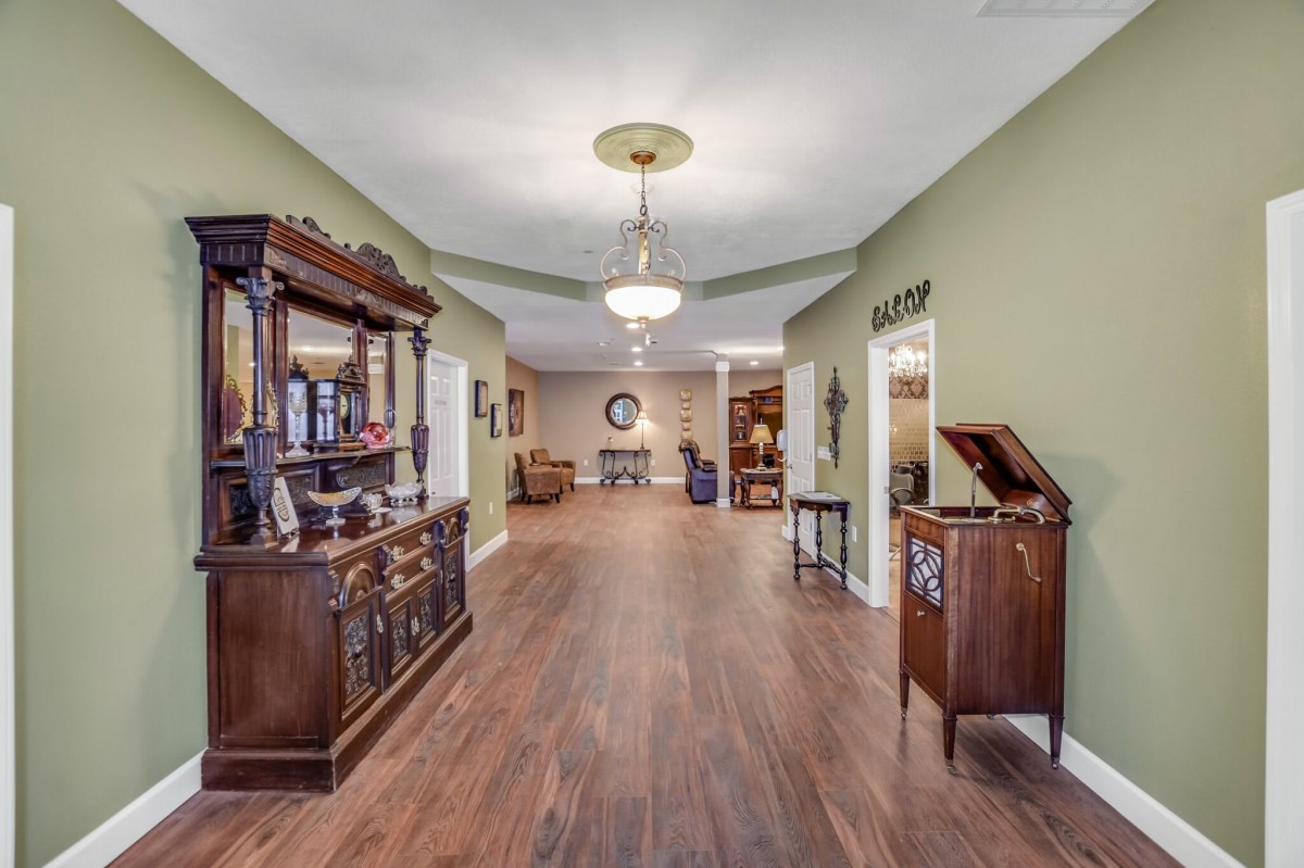 A spacious hallway with wooden furniture and elegant decor.