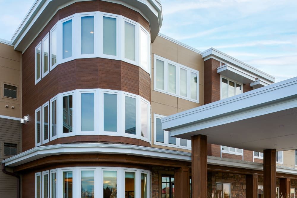 A contemporary building with a unique curved design and large windows.