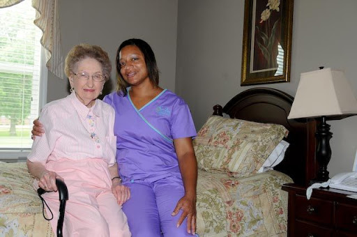 A heartwarming moment between an elderly resident and her caregiver, showcasing companionship and care.