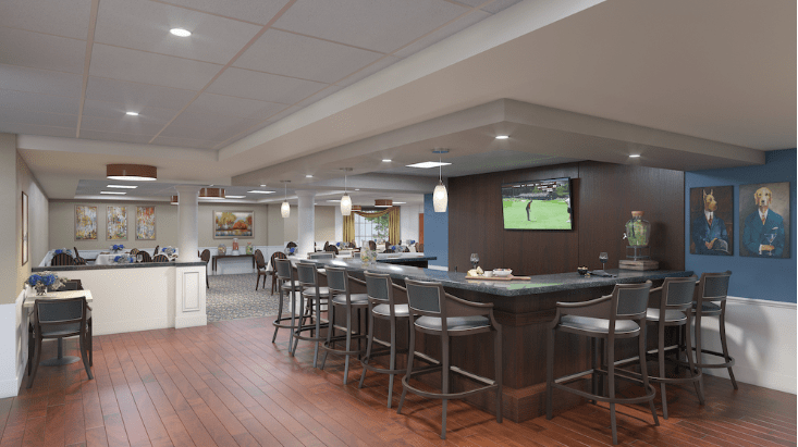 A modern bar and dining area with ample seating, featuring a television for entertainment.