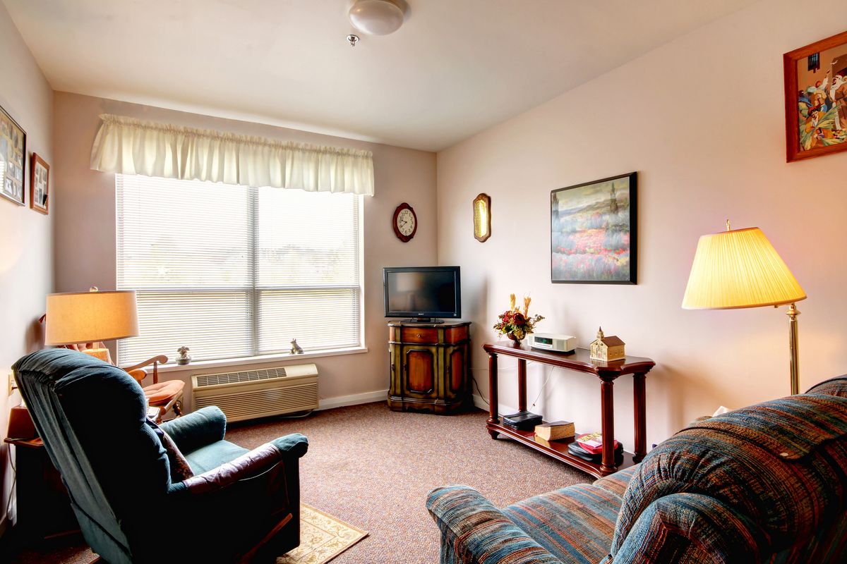 A cozy living room with a sofa, television, and decorative elements.