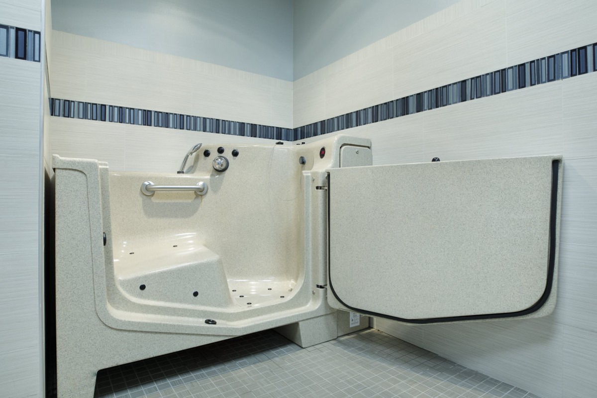 A walk-in bathtub designed for accessibility and safety in a modern bathroom.