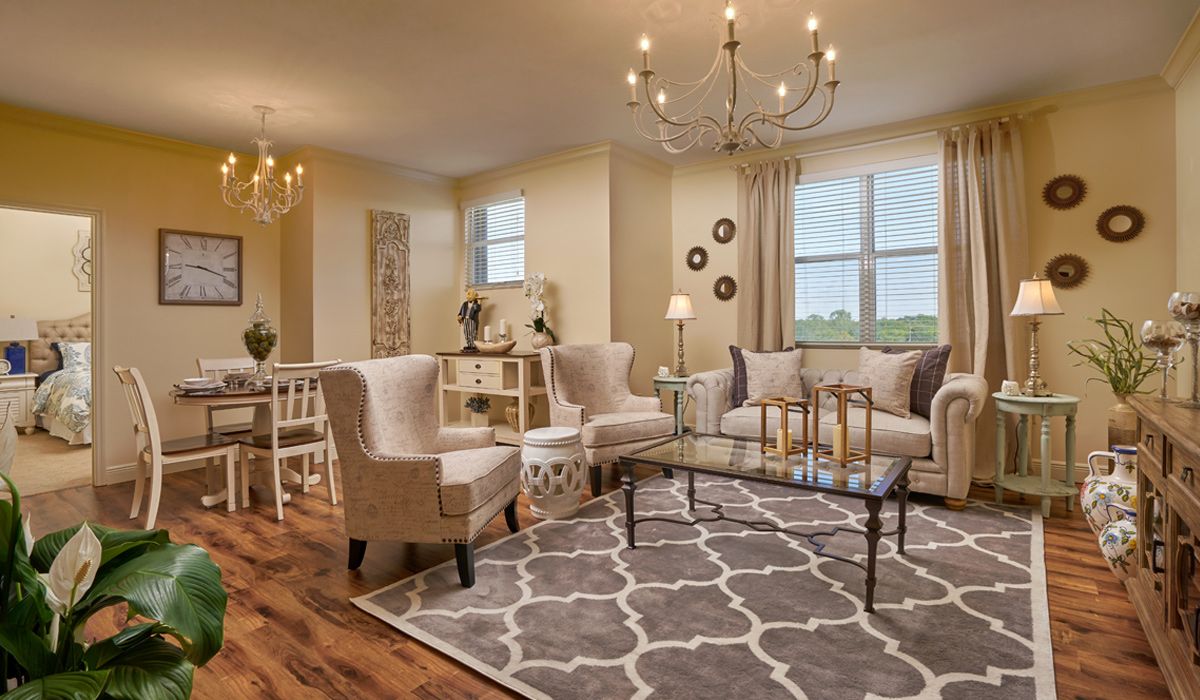 A stylish and cozy living room with elegant furniture and a chandelier.