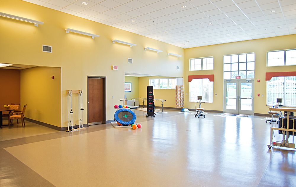 A spacious and bright dance studio with large mirrors and fitness equipment.