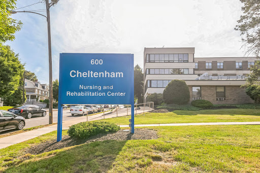 A view of the Cheltenham Rehabilitation Center building with a clear sign displaying its name and address.