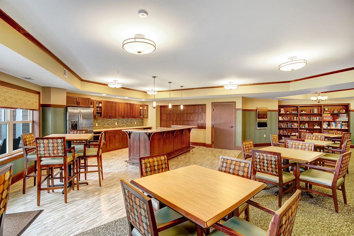 A modern kitchen and dining area with wooden furniture and warm lighting.