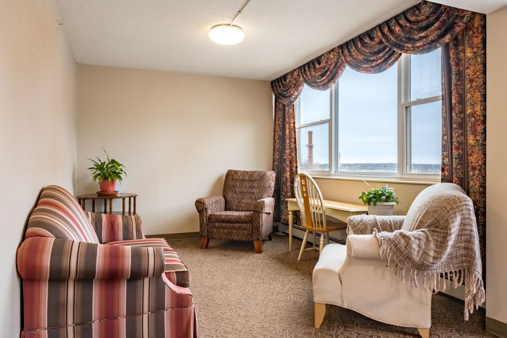 A cozy living room with comfortable seating and a large window overlooking the view.