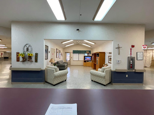 A spacious waiting area with comfortable seating and a television.