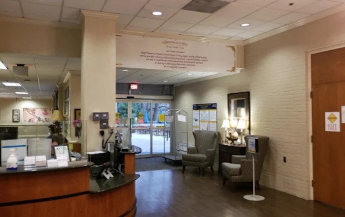 A welcoming lobby area with seating and decor near an entrance.