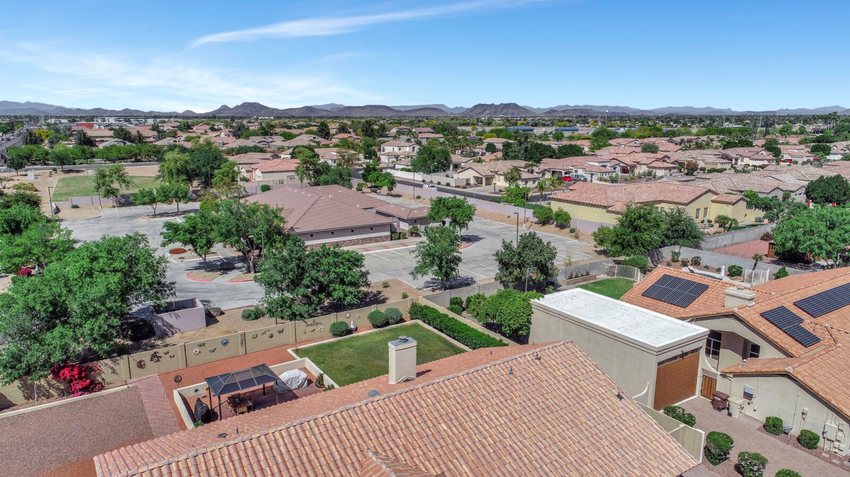 A scenic aerial view of a suburban neighborhood with houses and distant mountains.
