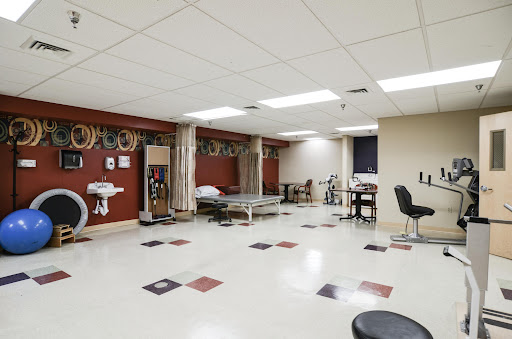 A spacious medical room equipped with hospital beds and various healthcare facilities.