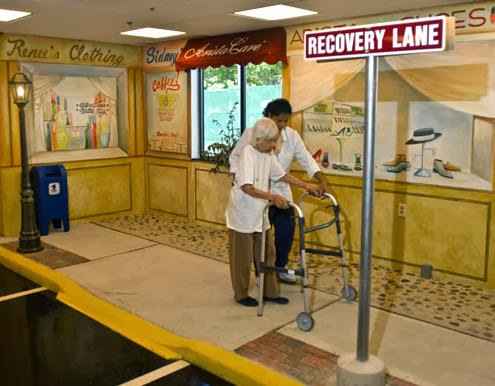 An elderly person receives assistance while using a walker in a recovery-themed setting.