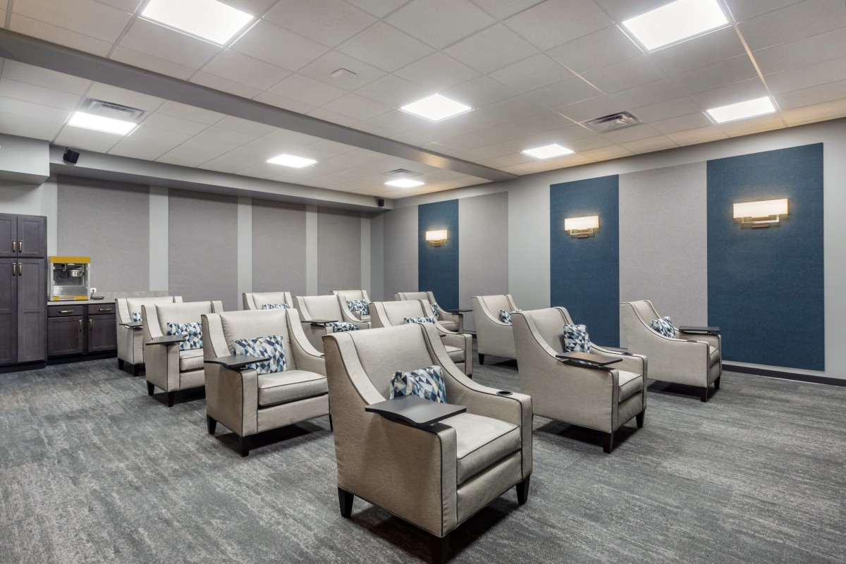 A luxurious home theater with comfortable seating and modern interior design.