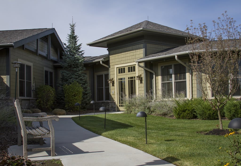 A modern residential house with a landscaped yard and walkway.