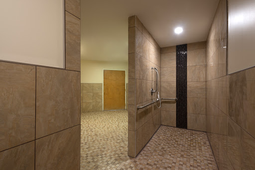 An accessible shower area with tiled walls and a spacious layout.