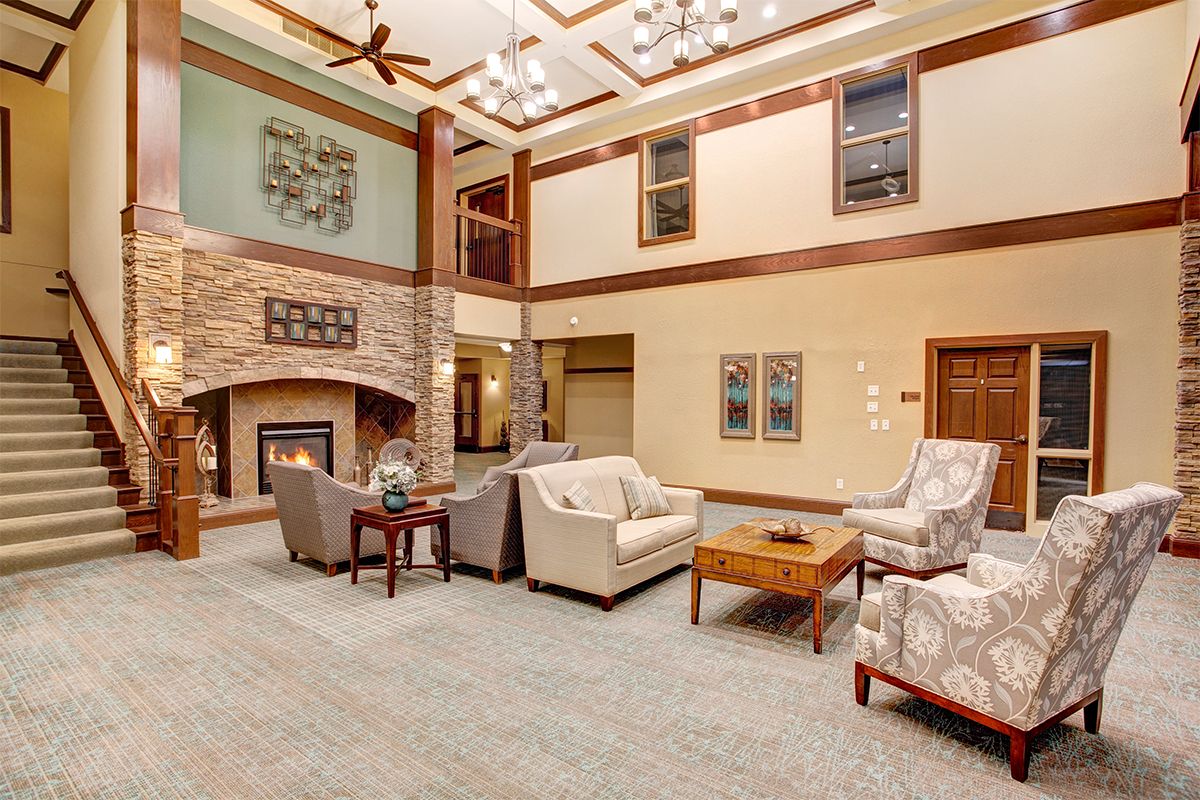 A spacious and elegantly designed living room with a cozy fireplace and comfortable seating.