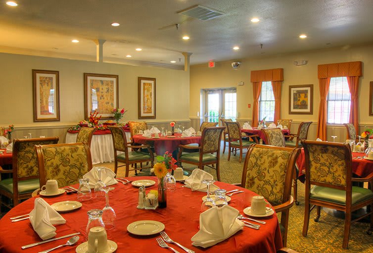 An elegant restaurant dining room with neatly arranged tables and chairs.