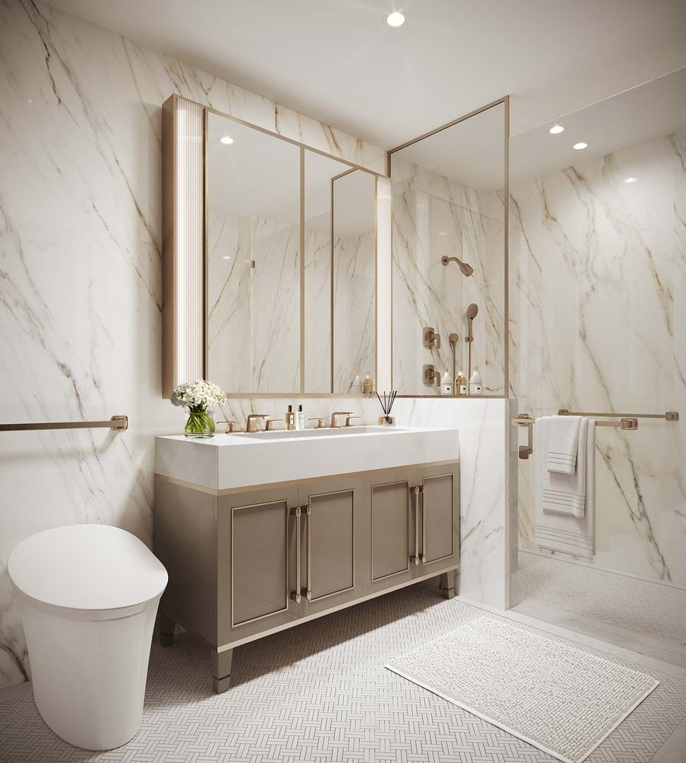 A modern and luxurious bathroom with marble walls, a vanity with large mirrors, and a glass-enclosed shower.