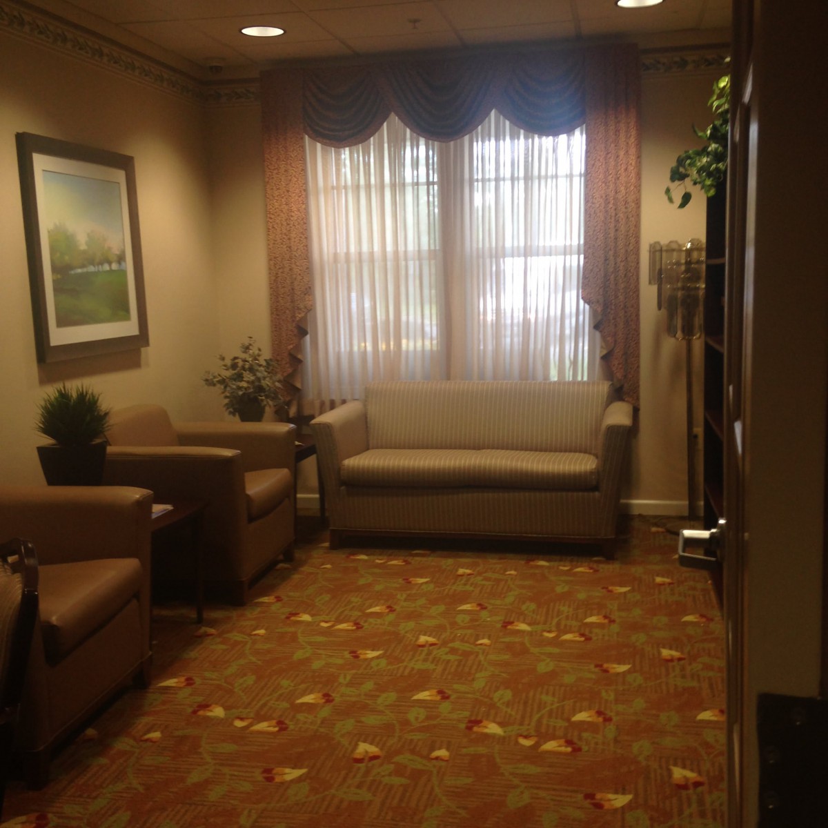 A cozy waiting room with seating and decor.