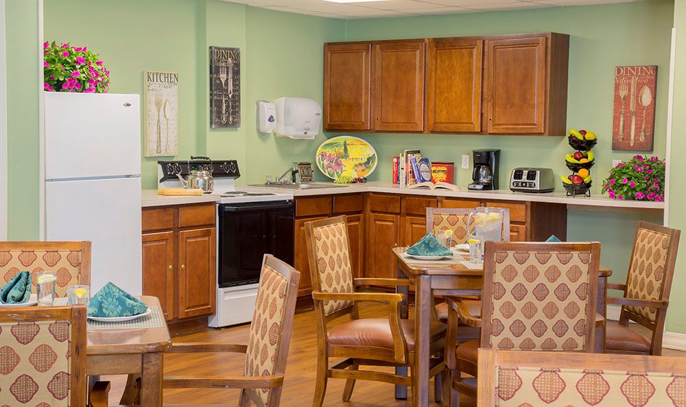 A cozy kitchen and dining area with wooden cabinets and furniture.