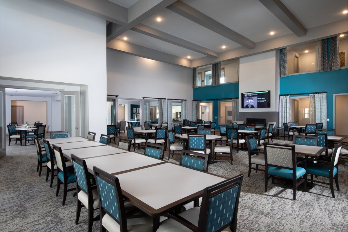 A spacious, modern dining area with neatly arranged tables and chairs.