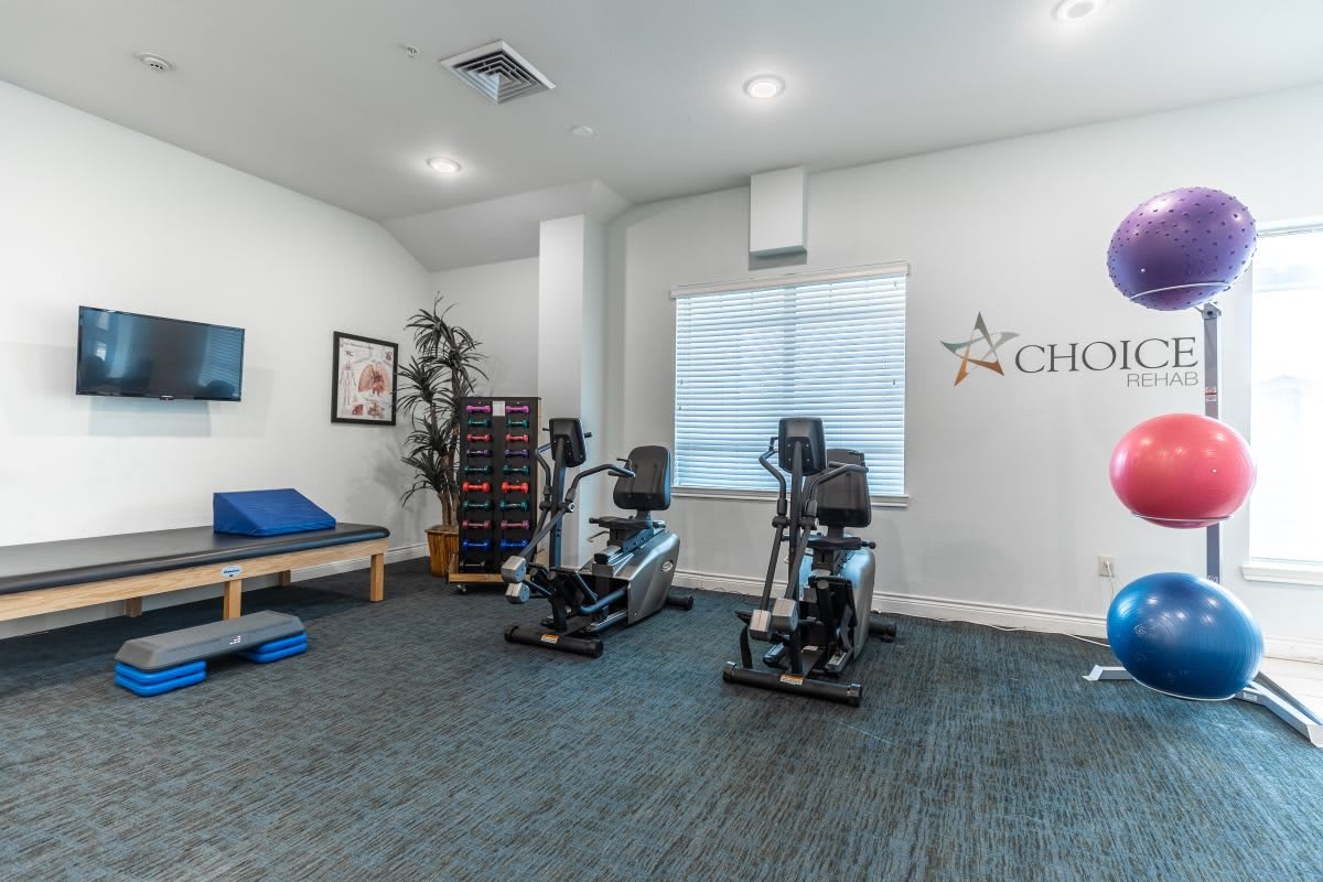 A modern gym with exercise bikes and fitness equipment.